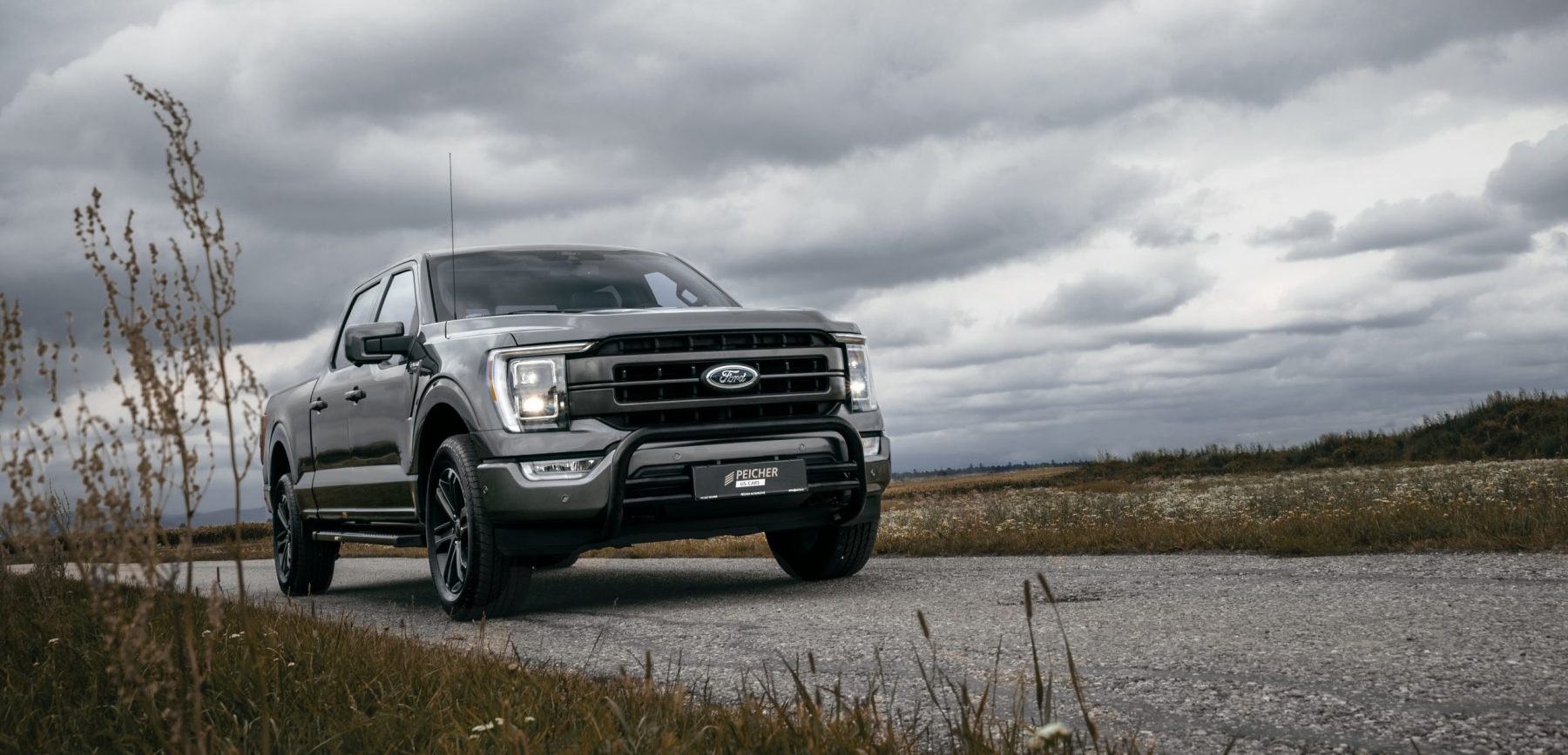 https://www.peicher-automotive.com/cms/wp-content/uploads/2021/12/2021-ford-f-150-lariat-sport-supercrew-longbed-magneticgrey-2-scaled-e1640074895652-1800x868.jpg